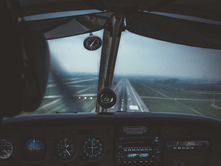 Small plane flying in clouds